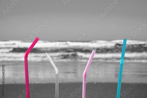 Plastic straw on sandy beach. Marine pollution image. 砂浜にあるプラスストロー 海洋汚染のイメージ 