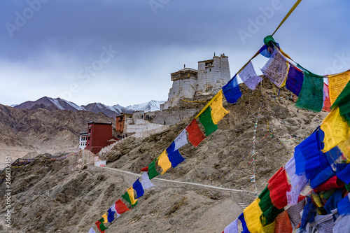 Namgyal Tsemo Gompa with prayer flags on the cliff of Namgyal hill and Himalayas. Leh, Ladakh, Jammu and Kashmir, India