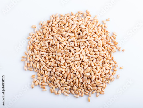 Heap of wheat grains isolated on white background.