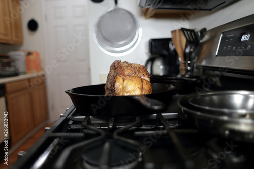 Εκτύπωση καμβά Baked prime rib roast resting on the stove top in a cast iron skillet