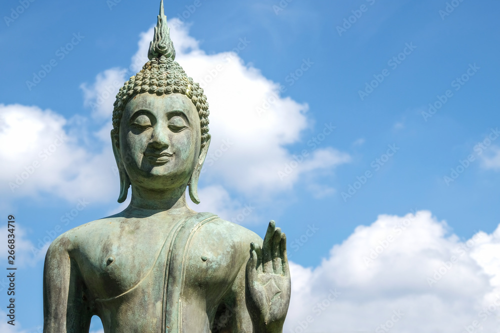 Close up of Bronze Buddha statue with beautiful sky. Buddha is the lord of Buddhist religion.