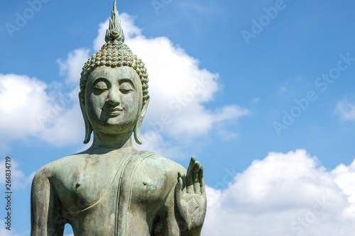 Close up of Bronze Buddha statue with beautiful sky. Buddha is the lord of Buddhist religion.