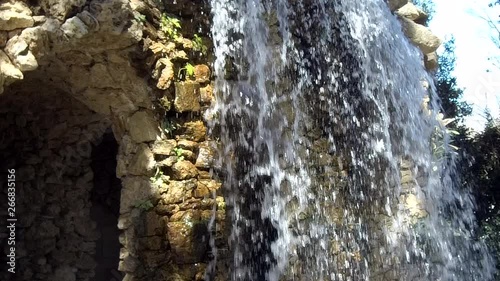 Waterfall over riverstones.