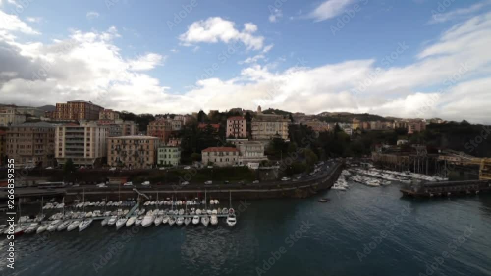 Overview from the sea of the port of Savona in Italy with traffic flowing along the coastal road. Realtime video Overview from the sea of the port of Savona in Italy with traffic flowing along the coastal road. Realtime video