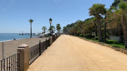 pov walk on paseo maritimo de marbella. 
natural walking motion.
summer walk next to the beach along teh golden mile in marbella, spain. 
spanish vacation holiday