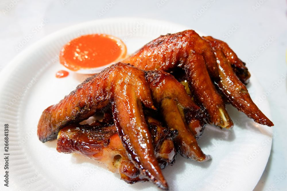 Baked chicken wings / barbecue chicken wings fried on white plate and sauce