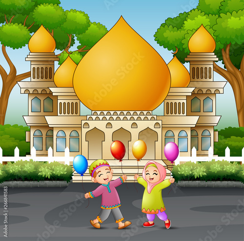 Happy Muslim Kids cartoon playing in front of a mosque photo