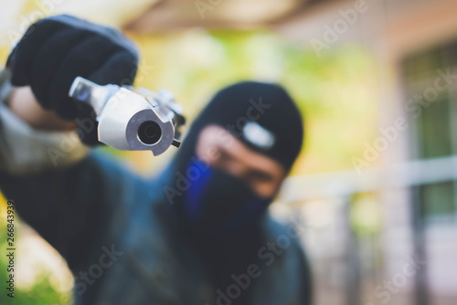 Gangster with a gun trying to rob car.