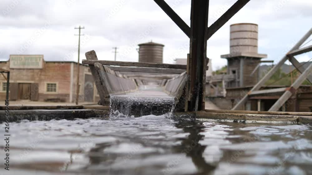 Flowing Water in a canal or irrigation ditch made out of wood in a far west scenario Flowing Water in a canal or irrigation ditch made out of wood in a far west scenario