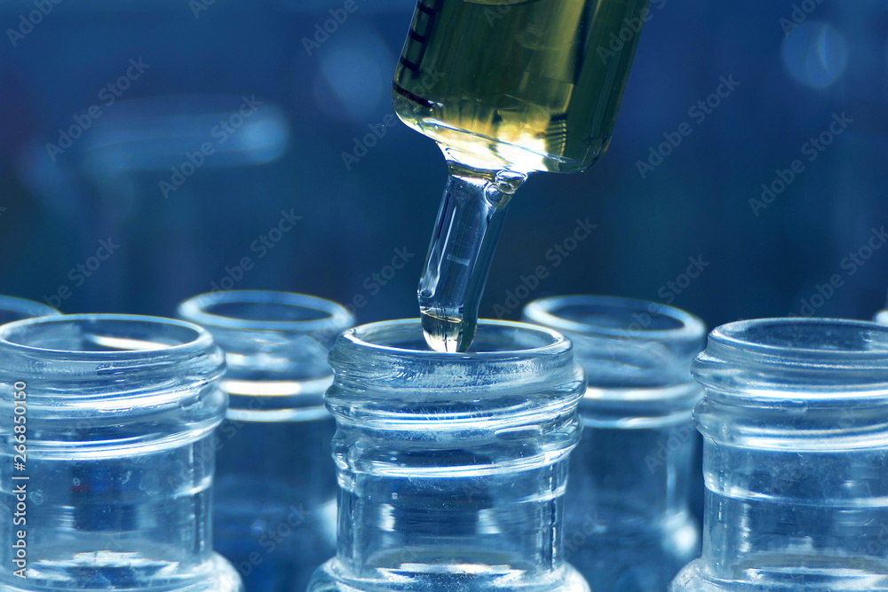 scientist using dropper sampling oil or chemical liquid drop to test tube with lab glassware in laboratory background, science or medical research and development concept scientist using dropper sampling oil or chemical liquid drop to test tube with lab glassware in laboratory background, science or medical research and development concept