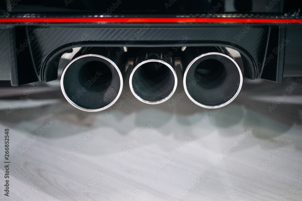 Modern sport car exhaust system pipes. Exhaust system of hot hatchback Stock Photo Adobe Stock