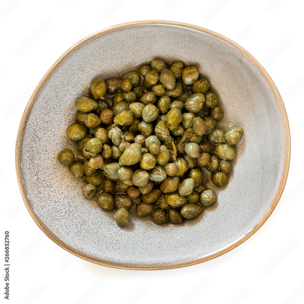 Baby Capers in Stoneware Bowl Top View Isolated on White Baby Capers in Stoneware Bowl Top View Isolated on White