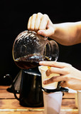 Barista making coffee, Barista pouring drip coffee into glass