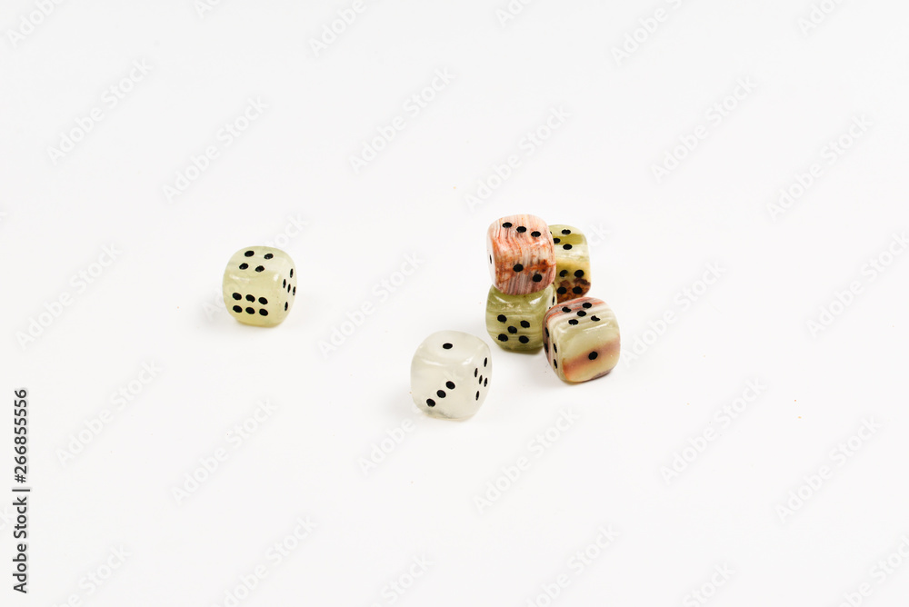 Dices made of natural stone on a white background. Copy space. Gaming. Dices made of natural stone on a white background. Copy space. Gaming.