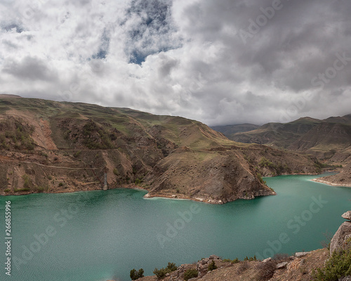 Mountain lake in the gorge with mountain peaks in the clouds. Lake Bylym in the Kabardino-Balkarian Republic of Russia photo