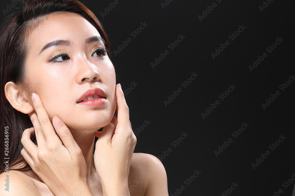 Young beautiful Asian woman makeup dark background Young beautiful Asian woman makeup dark background
