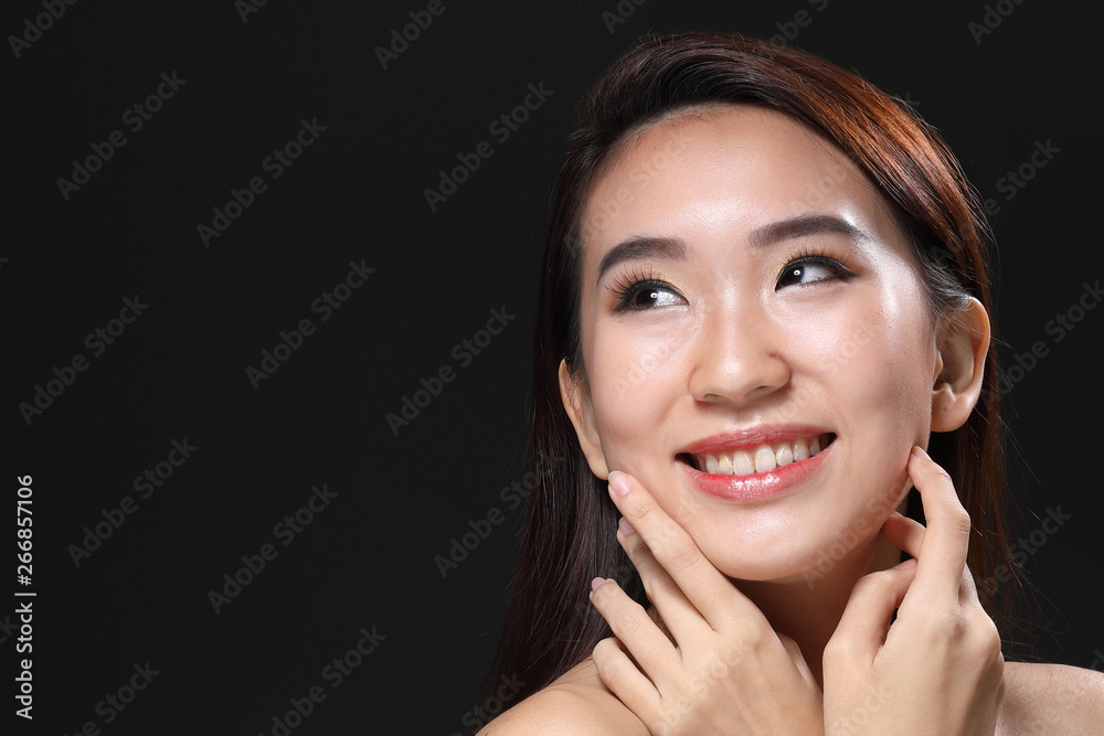 Young beautiful Asian woman makeup dark background Young beautiful Asian woman makeup dark background