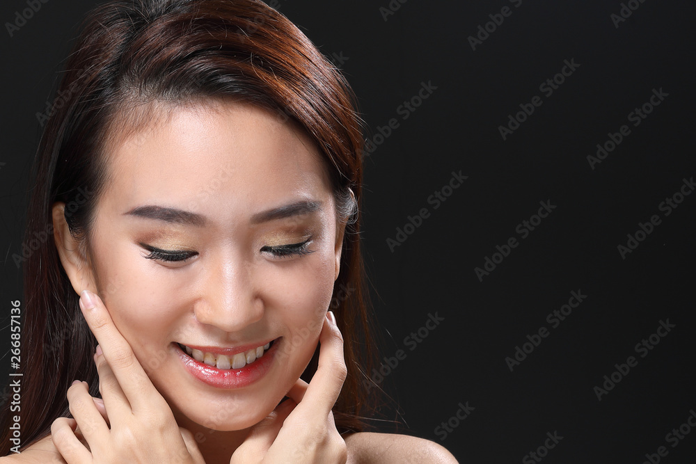 Young beautiful Asian woman makeup dark background Young beautiful Asian woman makeup dark background