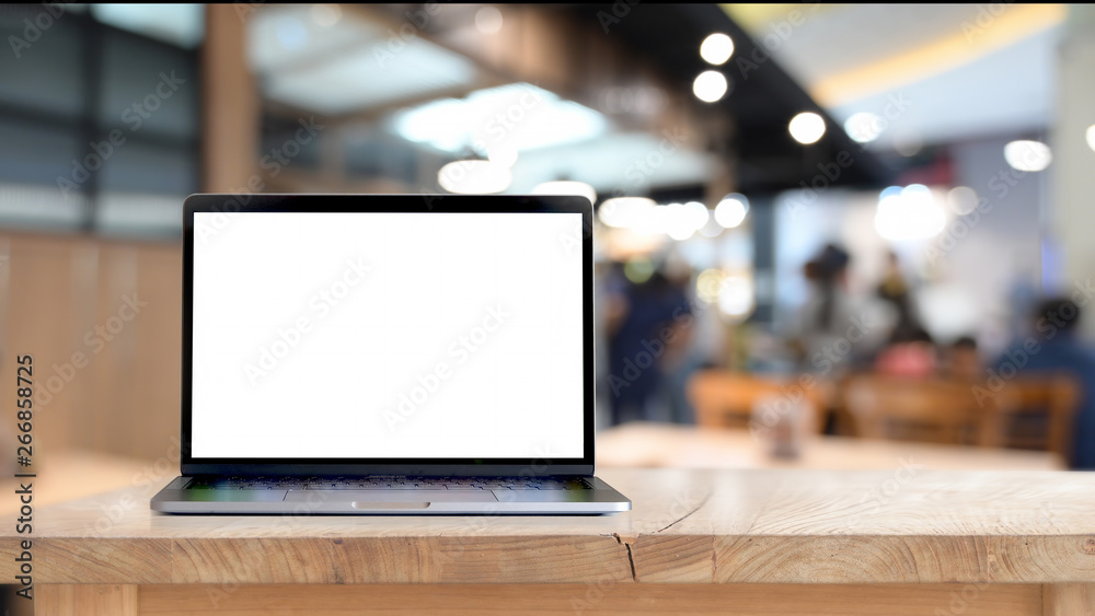 Mock up blank screen laptop on wood table - obrazy, fototapety, plakaty 