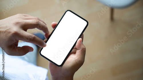 Top view man sitting and holding blank screen mock up mobile phone