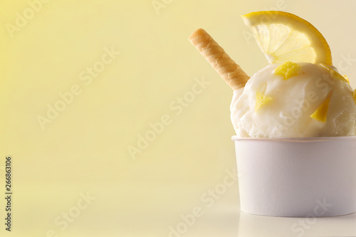Lemon ice cream cup on table isolated close up