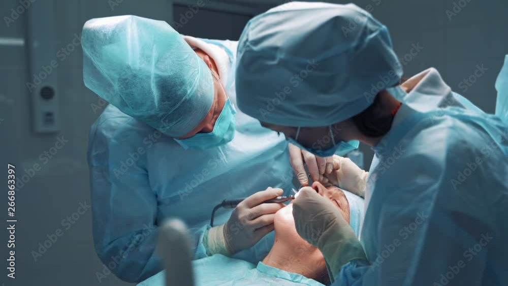 Doctor and assistent during operation. Dentist and a nurse treating a patient teeth Doctor and assistent during operation. Dentist and a nurse treating a patient teeth