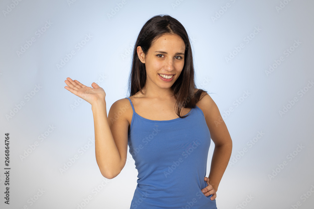 Pretty joyful teenager female showing your product on empty copy space feeling excited