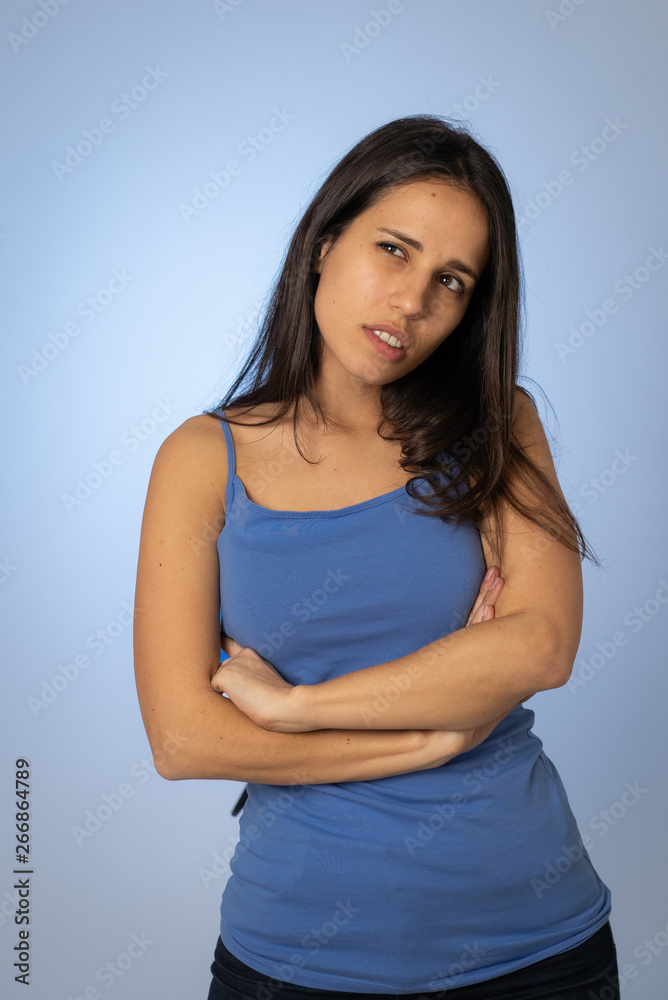 Portrait of young attractive woman with thoughtful expression thinking Portrait of young attractive woman with thoughtful expression thinking