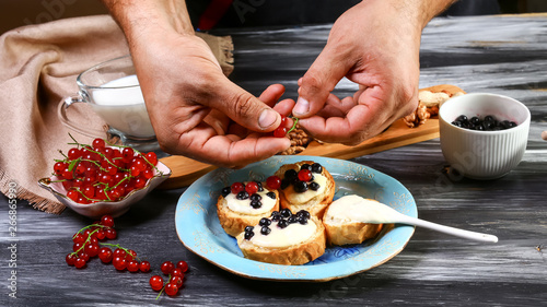 Cooking French toast with berries. Love for a healthy desserts concept. Food recipe on wooden background