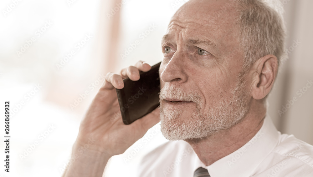Senior businessman talking on mobile phone Senior businessman talking on mobile phone