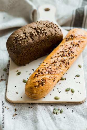 Freshly baked bread on dark grey fabric with seed