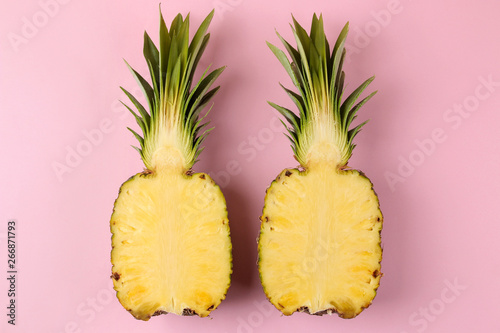 Large ripe fruit pineapple on a bright pink background. summer. top view.