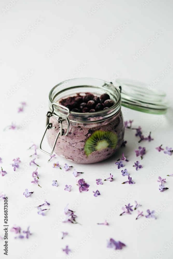 healthy smoothie breakfast in a glass jar with lilac flowers healthy smoothie breakfast in a glass jar with lilac flowers