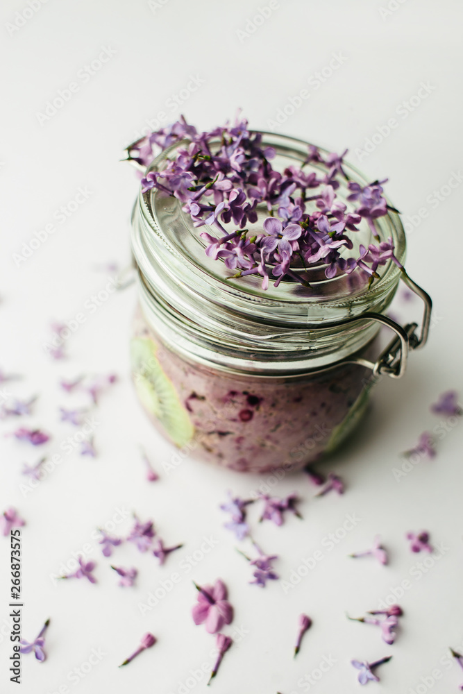 healthy smoothie breakfast in a glass jar with lilac flowers healthy smoothie breakfast in a glass jar with lilac flowers