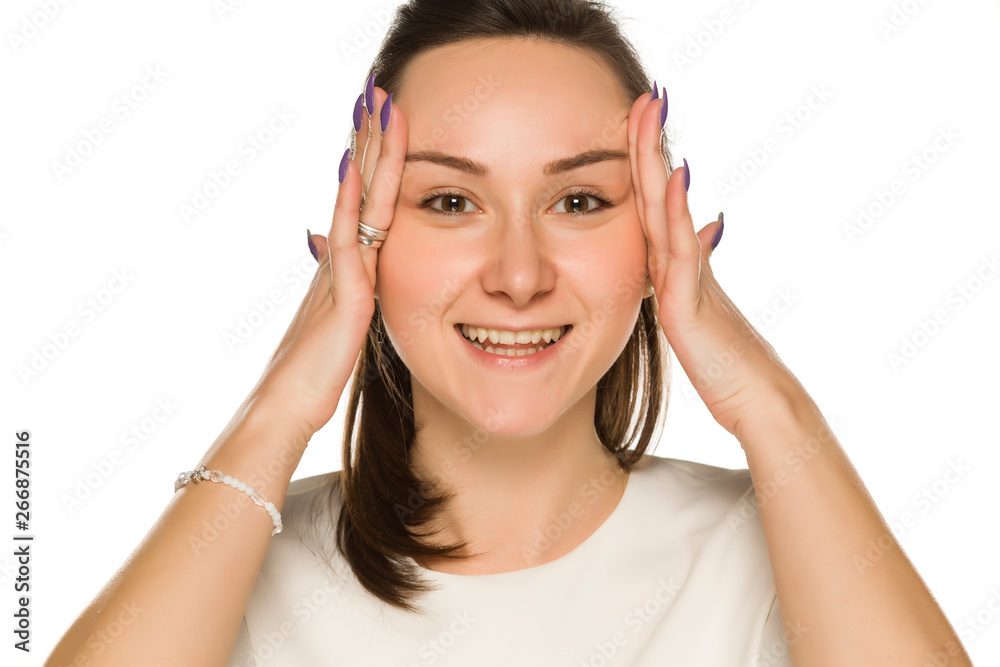 A woman tightening her face on white background A woman tightening her face on white background