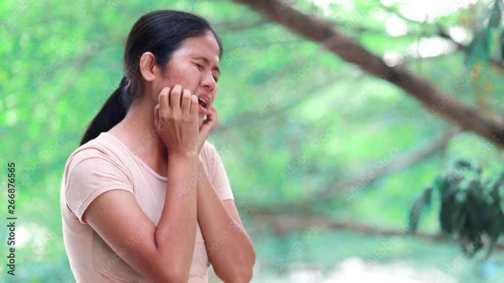 Young Asian Women is itching and scratching the face. Young Asian Women is itching and scratching the face.
