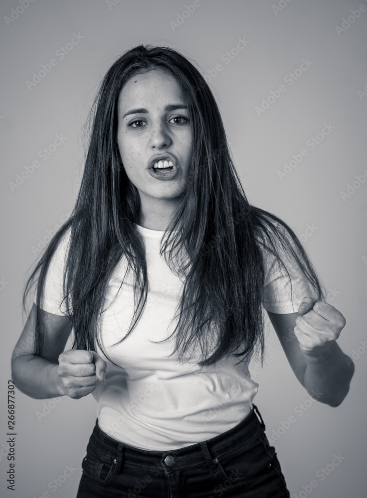 Portrait of beautiful young latin woman with angry and furious face. Human expressions and emotions Portrait of beautiful young latin woman with angry and furious face. Human expressions and emotions