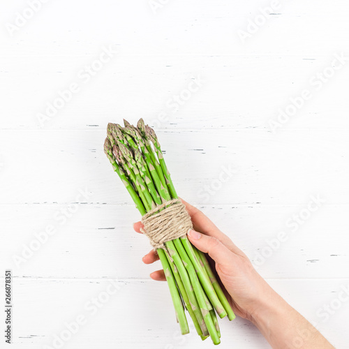 Fresh green asparagus in woman hands