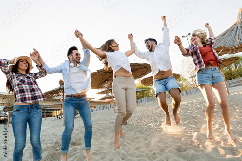 Group of young cheerful people bonding to each other and smiling