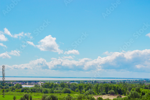 Cloudy sky above the water reservoir background. Abstract fpuffy cloudscape