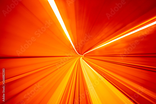 Abstract colorful concentric light trail accelerating through a tunnel.