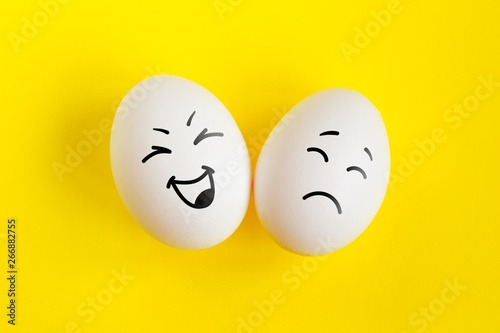 Photos Two white eggs on yellow background concept
