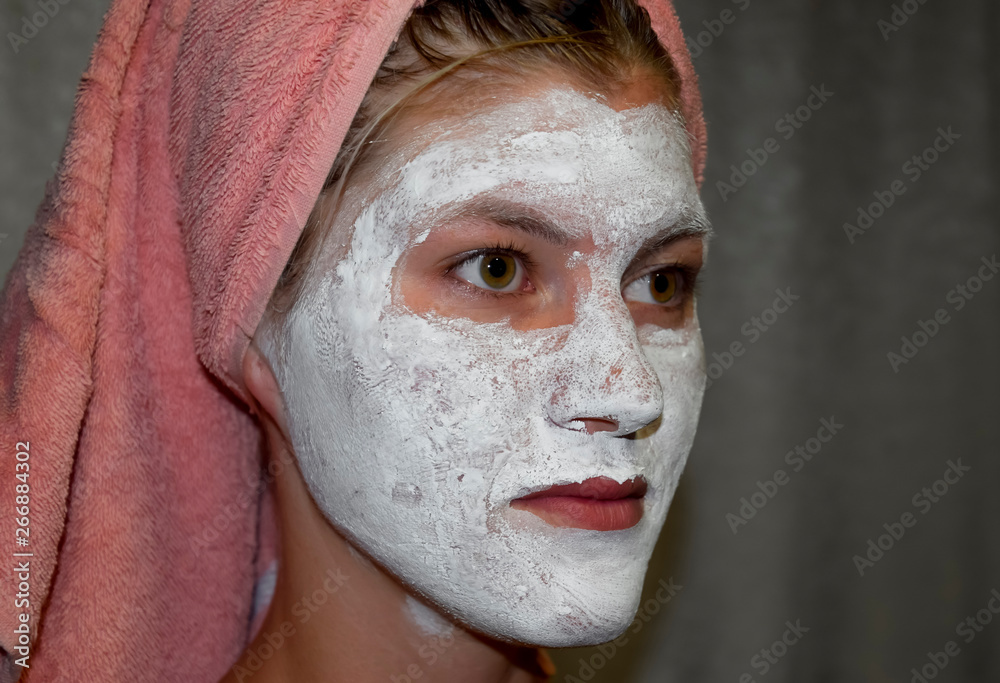 Cosmetic white face mask of toothpaste. Woman in white cosmetic mask Cosmetic white face mask of toothpaste. Woman in white cosmetic mask