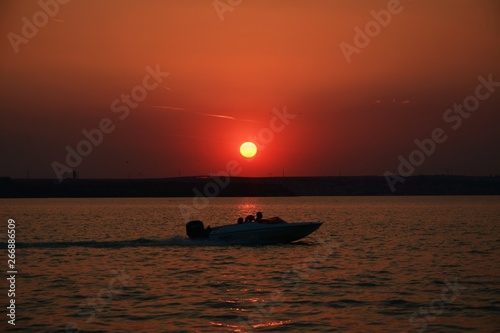a motor boat on the lake in the evening