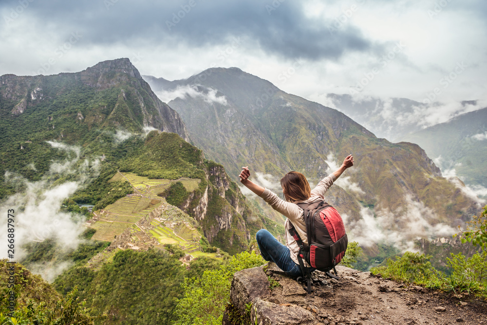 Girl-hiker looking on top of Huayna Picchu, looking on Machu Picchu