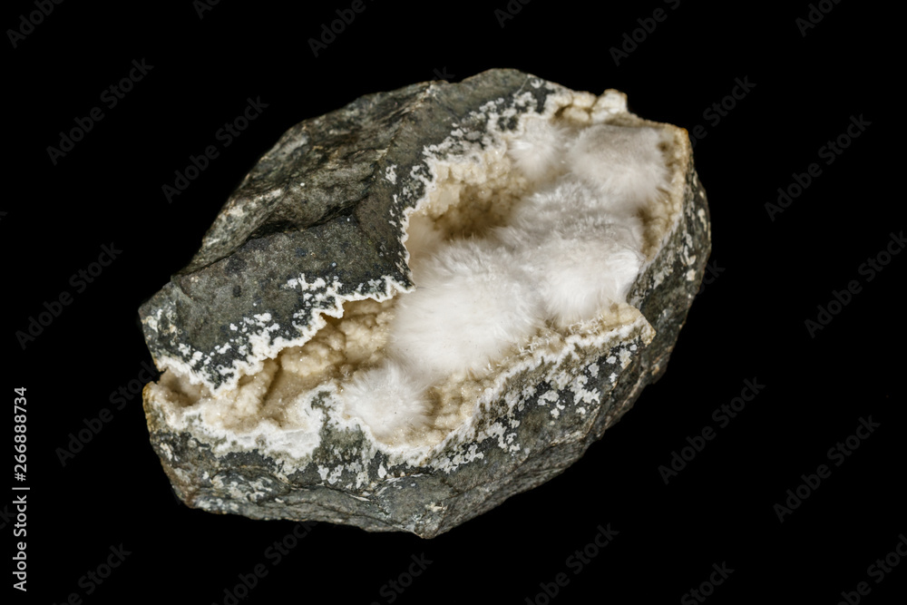 Macro stone Stilbite mineral on white black close up Macro stone Stilbite mineral on white black close up