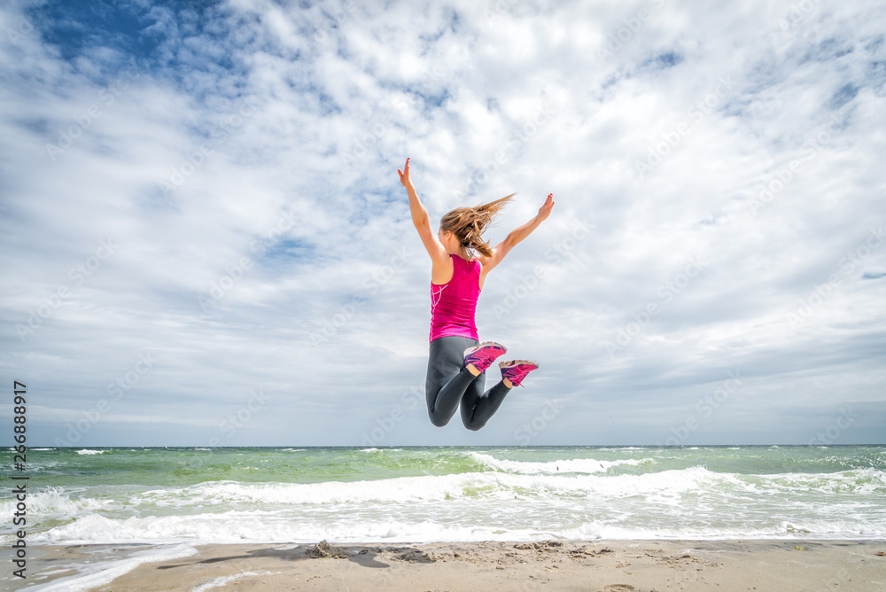 Happy beautiful young girl jumping