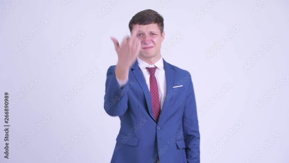 Angry young businessman complaining and showing middle finger