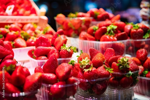 Plastic baskets with fresh red strawberries for sale
