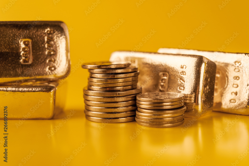 Gold bars and stack of gold coins. Background for finance banking concept. Trade in precious metals.